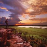 A visitor looking over the Nardab floodplains from Ubirr./>Covering nearly